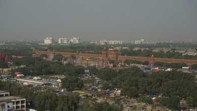 Overview of the Red Fort with surrounding trees and urban views, Delhi, India