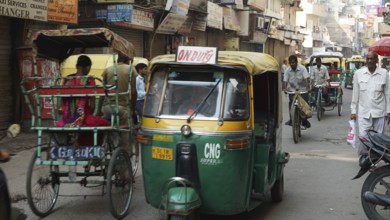 Busy street in India with rickshaws and people, dynamic city scene, Delhi