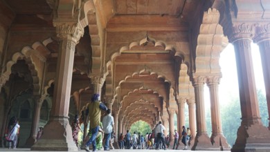 Red Fort in Delhi, historic arcades with imposing pillars and people below, Delhi, India