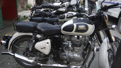 Several parked Royal Enfield motorcycles in a row, Manali, Himachal Pradesh, India