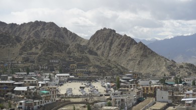 City view of Leh with mountains in the background under a cloudy sky, Ladakh, North India,