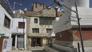 Street scene in Leh with temple, Leh Palace and characteristic architecture and blue sky, Ladakh,