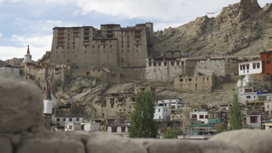 Leh Palace, large historic fortress surrounded by traditional houses of a settlement, Ladakh, North