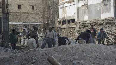 Workers on a construction site in Leh working on a building in harsh conditions, Ladakh, North
