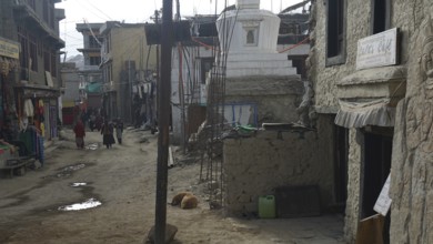 Side road in Leh surrounded by traditional buildings and cloudy weather, Leh, Ladakh, North India,