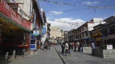 Busy street in Leh with traditional shops and flying prayer flags, Ladakh, North India, Himalayas,