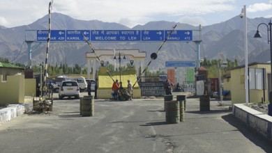 Entrance to Leh with a welcome sign and views of the surrounding mountains, Leh, Ladakh, North