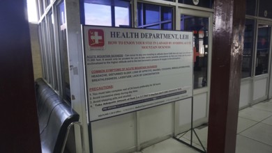 Information sign about altitude sickness at Leh airport with preventive measures in a building,