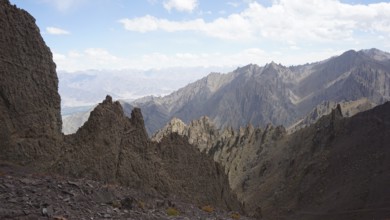 Rough, angular mountain formations under clear blue sky, trekking at Stok La Pass in Ladakh,