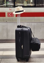 Luggage left alone with hat on platform in front of Intercity Express ICE, Berlin Central Station,