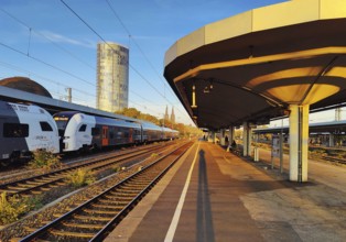 On the train track with a view of the Cologne Triangle skyscraper at sunrise, Deutzer Bahnhof,