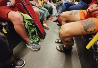 Show me your legs, show me your shoes, lots of people on an S-Bahn in Berlin, Germany