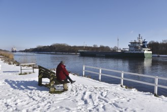 Woman, senior woman sitting on a bench on the Kiel Canal, NOK, Kiel Canal, Kielcanal,