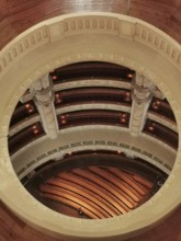 View of a round, elegant interior with wooden floors and rows of seats, Dresden