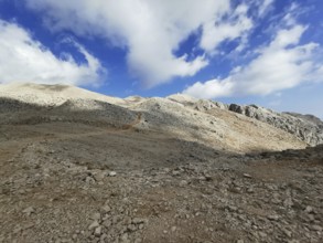 Rocky mountains with dramatic light and shadow effects in the sky, climbing Tahtali Dagi, Lycia,