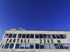Building at the summit of Tahtali Dagi and altitude 2365 meters, under a deep blue sky, climbing