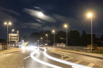 Night scene at the old Elbe bridge with traffic, lanterns and full moon, Meissen, Saxony, Germany