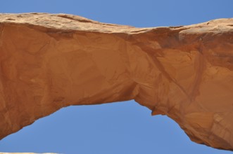 Skyline Arch, a sand-colored rock arch standing out against the blue sky, Arches National Park,