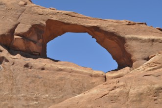 Skyline Arch, a sandstone arch under clear blue sky, Arches National Park, Utah, USA