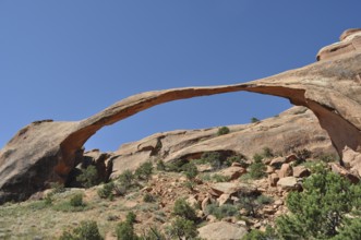 Landscape Arch, a natural sandstone bridge with clear sky in the background, Arches National Park,