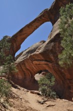 Double O Arch, a double rock arch arching gracefully in a sunny desert landscape, Arches National