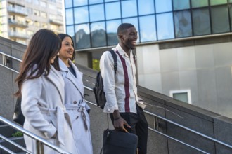 Diverse co workers and friends laughing and having a pleasant conversation while descending outdoor