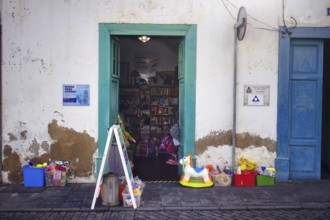 Landscape image of a shop front in Arrecife, Lanzarote. Two wide open doors offer a view of the