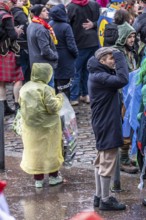 Pawn collector in the old town moving on Rose Monday in Düsseldorf, North Rhine-Westphalia, Germany