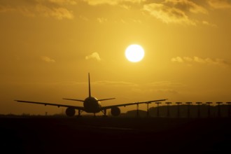 Boeing 777 A7-BFL commercial jet aircraft of Qatar cargo waiting to take off silhouette at sunset