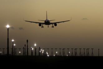 Airbus 320 commercial passenger airliner jet aircraft in flight on approach to land over runway