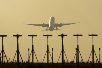 Commercial passenger airliner jet aircraft taking off in flight at sunset at London Stansted