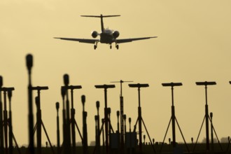 Cessna Citation small executive business jet aircraft in flight on approach to land over runway