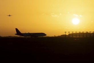 Airbus commercial passenger airliner jet aircraft taking off in flight with another plane on the