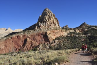 Proud rock formation rising above migrating people, Capitol Reef National Park, Utha, USA