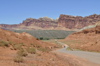 Extensive road through a landscape of red rocks and clear blue sky, Capitol Reef National Park,