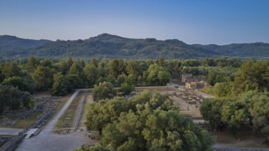 Soft morning light, Leonidaion, landscape with ruins and thick forests in the background, drone