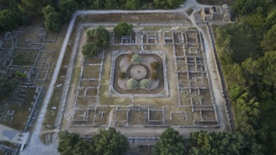 Soft morning light, Leonidaion, square ancient ruins with blooming trees in the middle, drone shot,