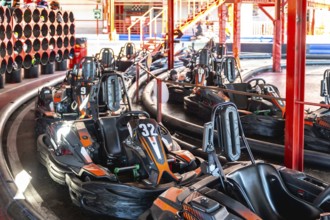 Go karts lining up on a designated track, preparing for a recreational racing session at an