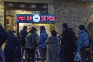 Istanbul, Turkey. January 3rd 2025. A queue of customers line up at a popular stall selling Balik