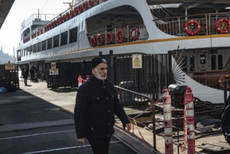 Istanbul, Turkey. January 3rd 2025. A Turkish man disembarks a ferry docked at Karakoy ferry port