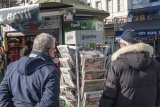 Istanbul, Turkey. January 3rd 2025. Turkish customers browse newspapers and magazines outside a