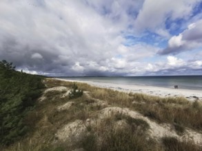 Quiet beach with clouds in the sky and dunes in the foreground, Rügen, Baltic Sea