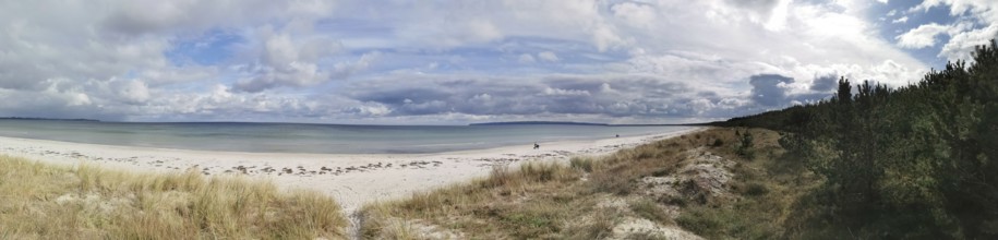 Wide beach landscape with clear sea under cloudy sky, Rügen, Baltic Sea