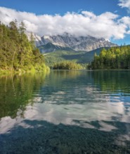 View over Lake Eibsee lake, the Wetterstein Mountains with the Zugspitze in the background, clouds
