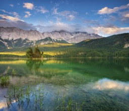Evening on Lake Eibsee lake, the Wetterstein Mountains with the Zugspitze in the background, clouds