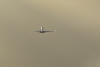 Gulfstream executive business jet aircraft in flight at sunset at London Stansted airport, Essex,