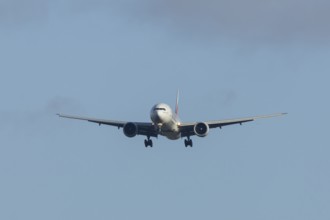Boeing 777 commercial passenger airliner jet aircraft of Emirates airways in flight on approach to