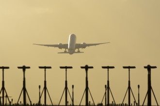 Commercial passenger airliner jet aircraft taking off in flight at sunset at London Stansted
