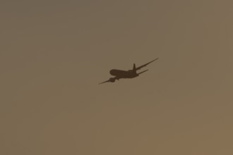 Boeing 777 A7-BFL commercial jet aircraft of Qatar cargo in flight silhouette at sunset at London