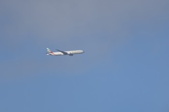 Boeing 777 commercial passenger airliner jet aircraft of Emirates airways in flight at London